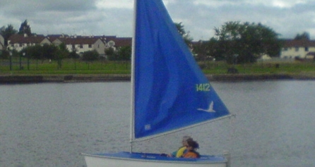 Two people sailing on a small boat